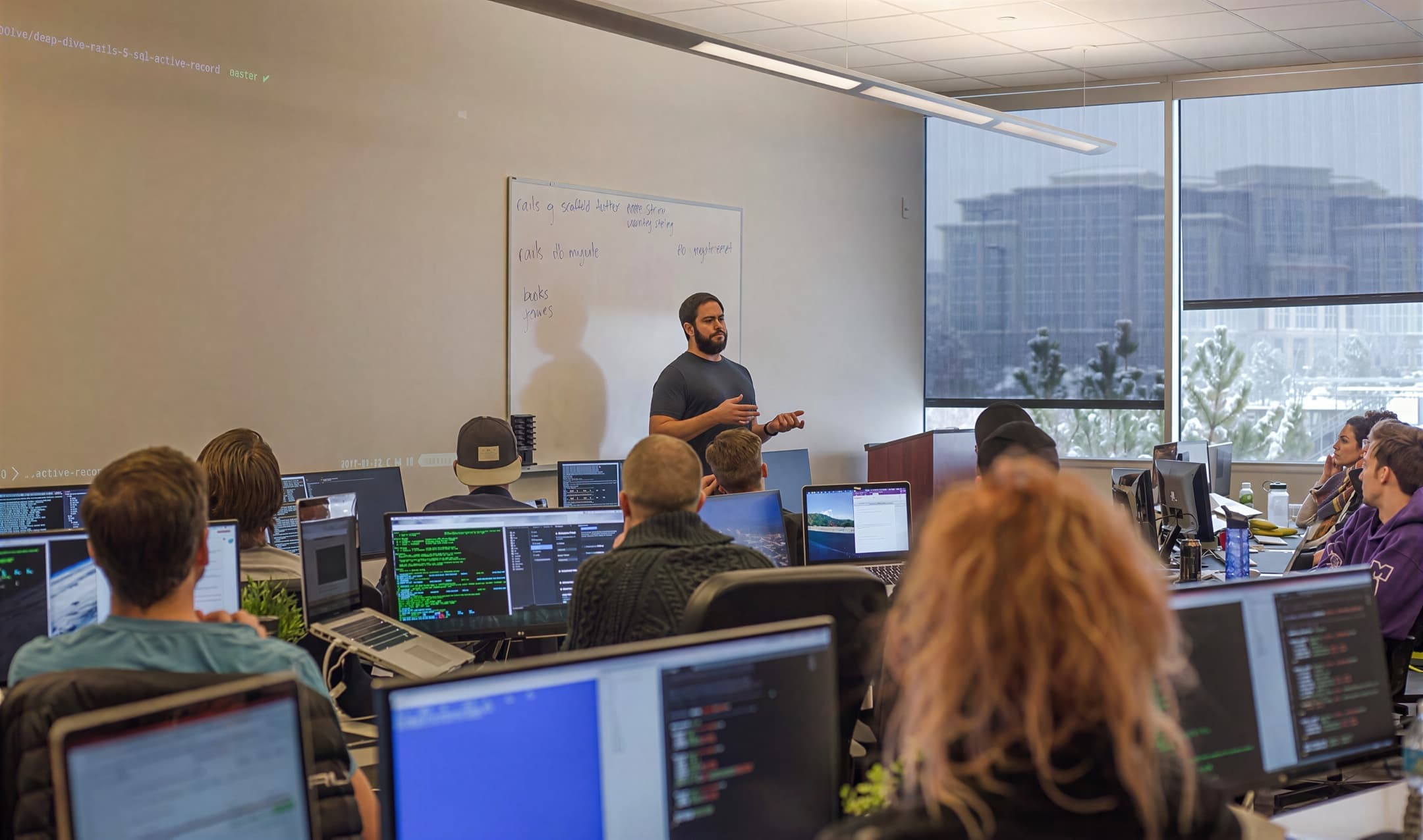 Jordan teaching a classroom of developers working at their computers